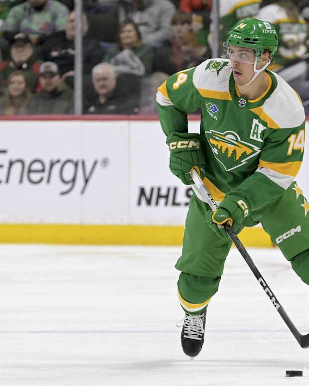 Feb 17, 2024; Saint Paul, Minnesota, USA; Minnesota Wild forward Joel Eriksson Ek (14) skates with the puck against the Buffalo Sabres during the second period at Xcel Energy Center.